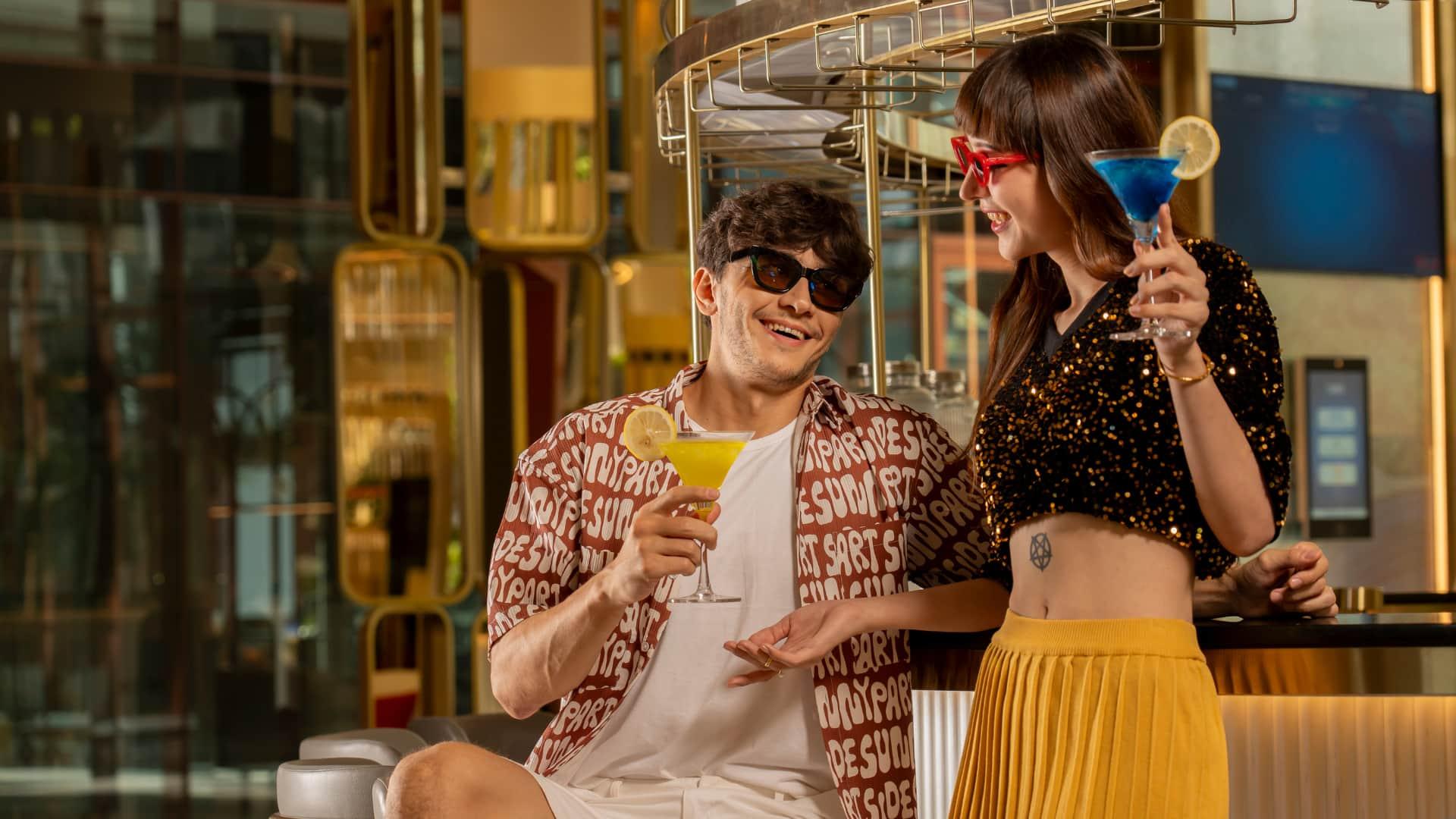 Couple enjoying cocktails at bar