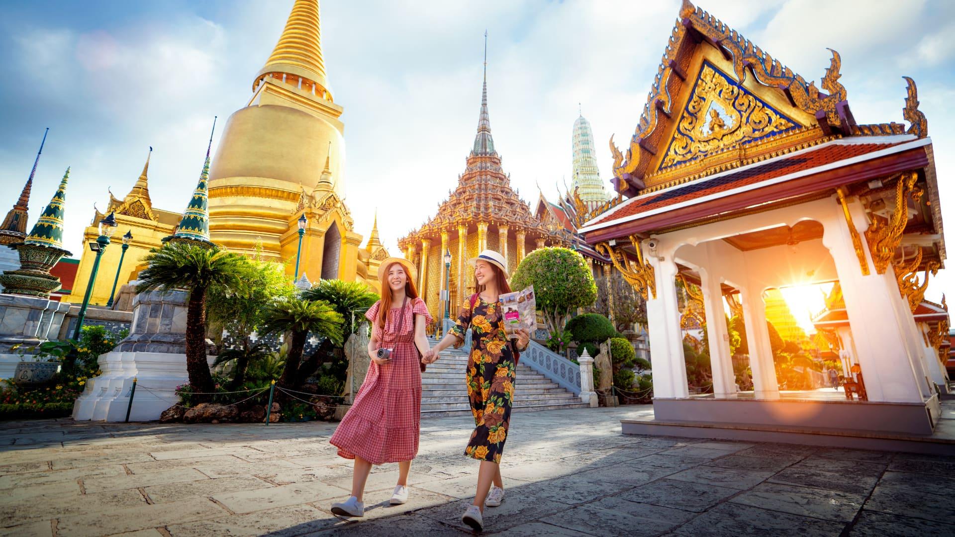 Two tourists visiting temples in Thailand