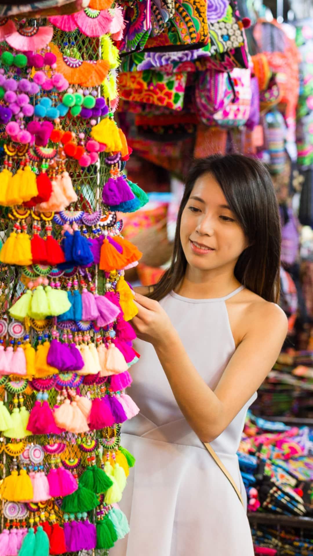 Woman browsing items at a Thailand street market